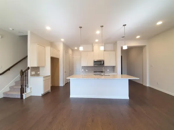 a view of kitchen with kitchen island stainless steel appliances sink refrigerator and stove