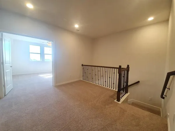 a view of a kitchen with a fridge and wooden floor