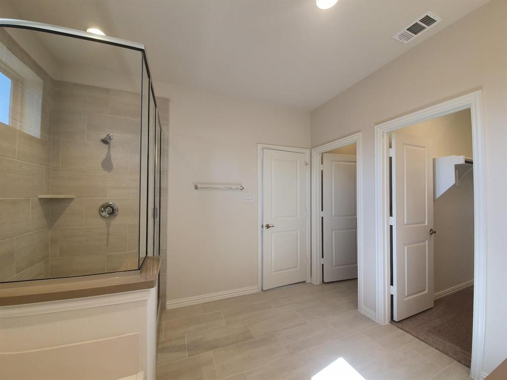 8286 Primrose Way Dallas, TX 75252 - Photo 14 of 25 a bathroom with a shower and a glass door