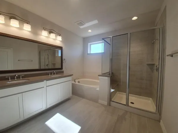 a bathroom with a shower and a glass door