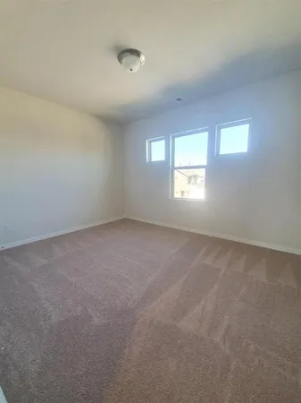 a view of a kitchen with a sink and a refrigerator