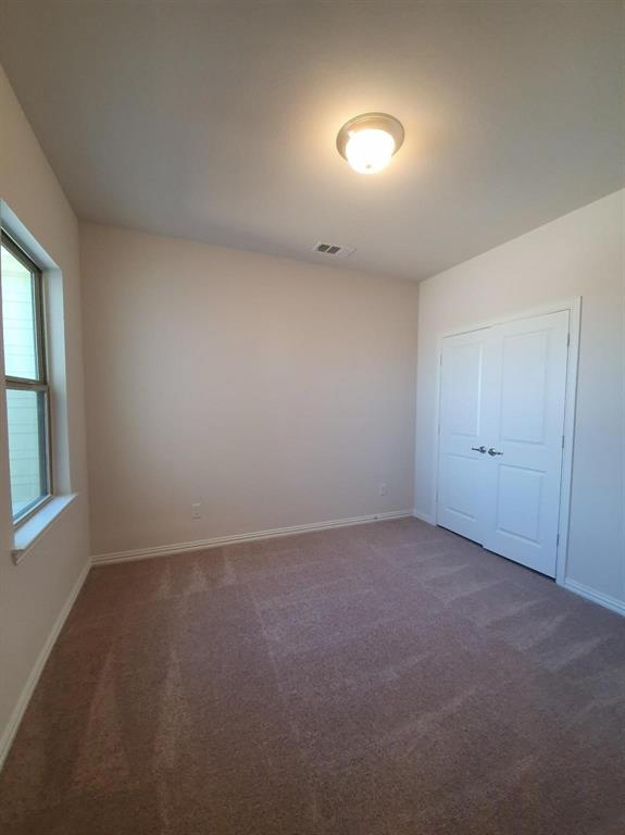 8286 Primrose Way Dallas, TX 75252 - Photo 18 of 25 an empty room with a empty space and windows