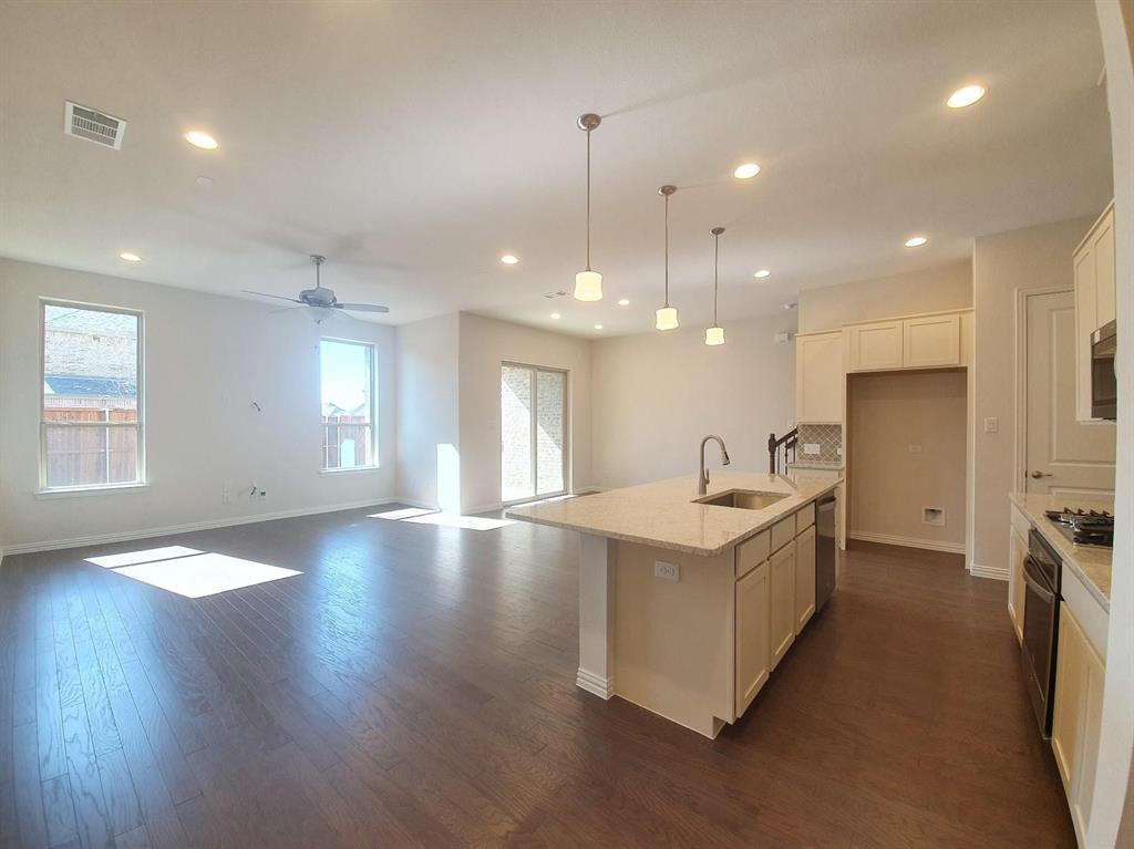 8286 Primrose Way Dallas, TX 75252 - Photo 24 of 25 a view of a kitchen sink and a wooden floor
