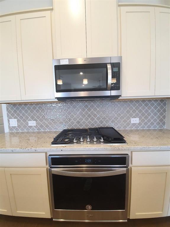 8286 Primrose Way Dallas, TX 75252 - Photo 4 of 25 a stove top oven sitting inside of a kitchen