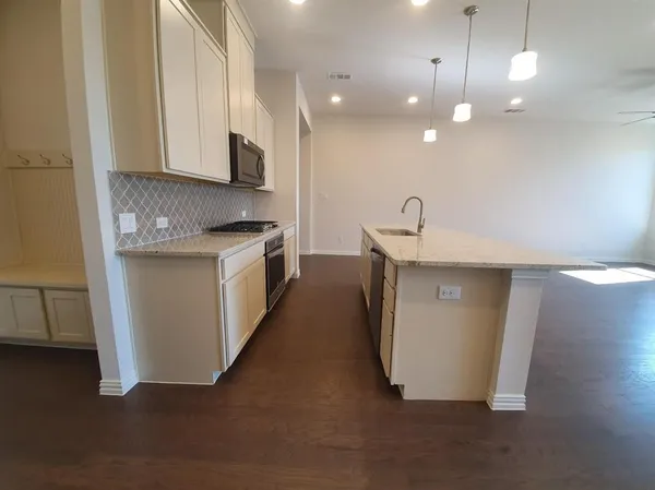 a large kitchen with a lot of counter space and a refrigerator