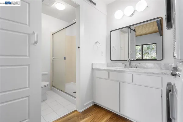 a bathroom with a shower sink and mirror