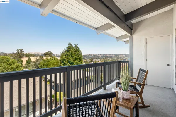 a view of a balcony with chair and wooden floor