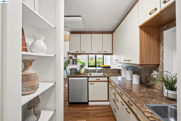 a kitchen with a sink cabinets and window