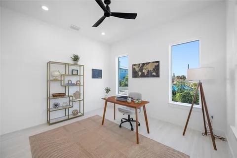 a kitchen with white cabinets and sink