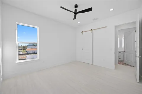 a bathroom with a granite countertop sink mirror and toilet