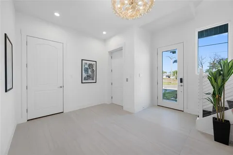 an aerial view of beach and residential houses with outdoor space