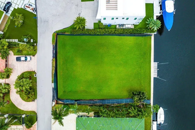 an aerial view of a house with a garden and lake view