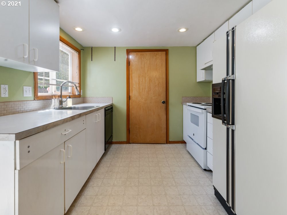 8106 Southeast Knight Street Portland, OR 97206 - Photo 18 of 29 a kitchen with stainless steel appliances granite countertop a refrigerator and a sink