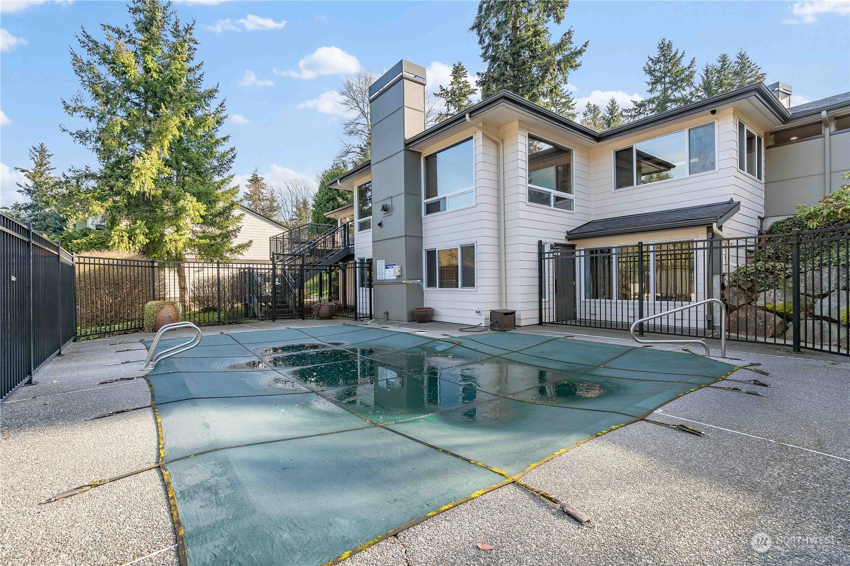 31500 33rd Place Southwest, Unit R204 Federal Way, WA 98023 - Photo 14 of 26 a view of a white house next to a yard with plants and trees