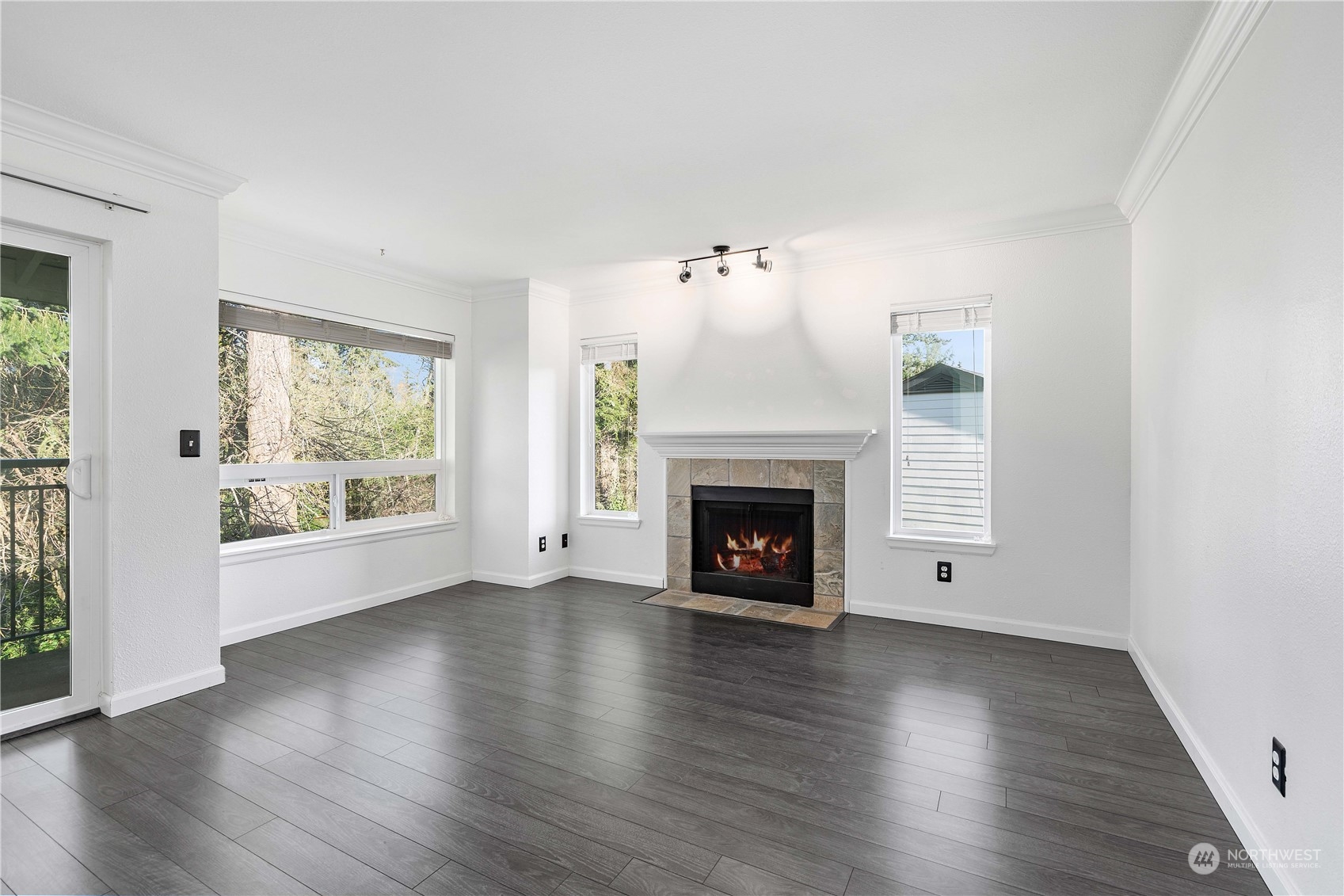 31500 33rd Place Southwest, Unit R204 Federal Way, WA 98023 - Photo 3 of 26 an empty room with wooden floor fireplace and windows