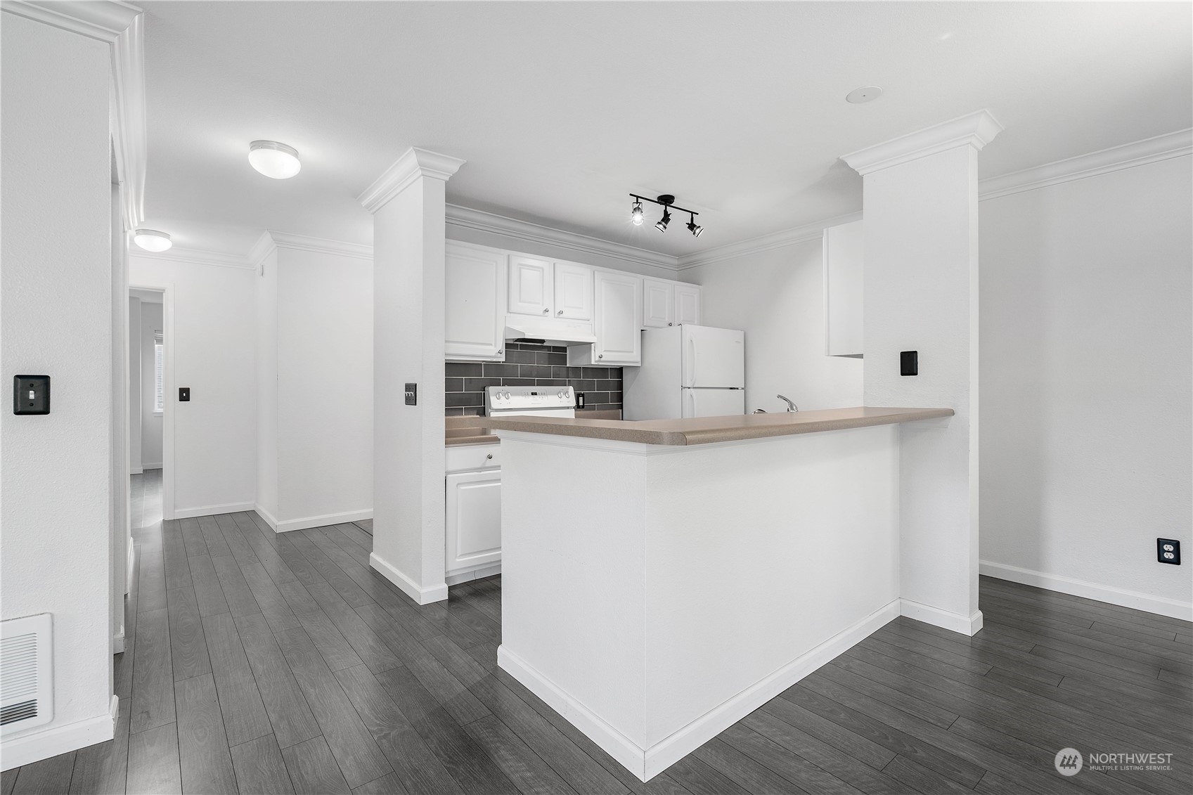 31500 33rd Place Southwest, Unit R204 Federal Way, WA 98023 - Photo 5 of 26 a kitchen with kitchen island white cabinets and stainless steel appliances