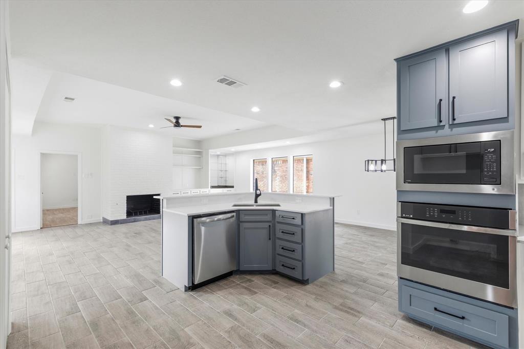 17003 Davenport Road Dallas, TX 75248 - Photo 15 of 40 a large kitchen with stainless steel appliances granite countertop a stove a sink and a microwave