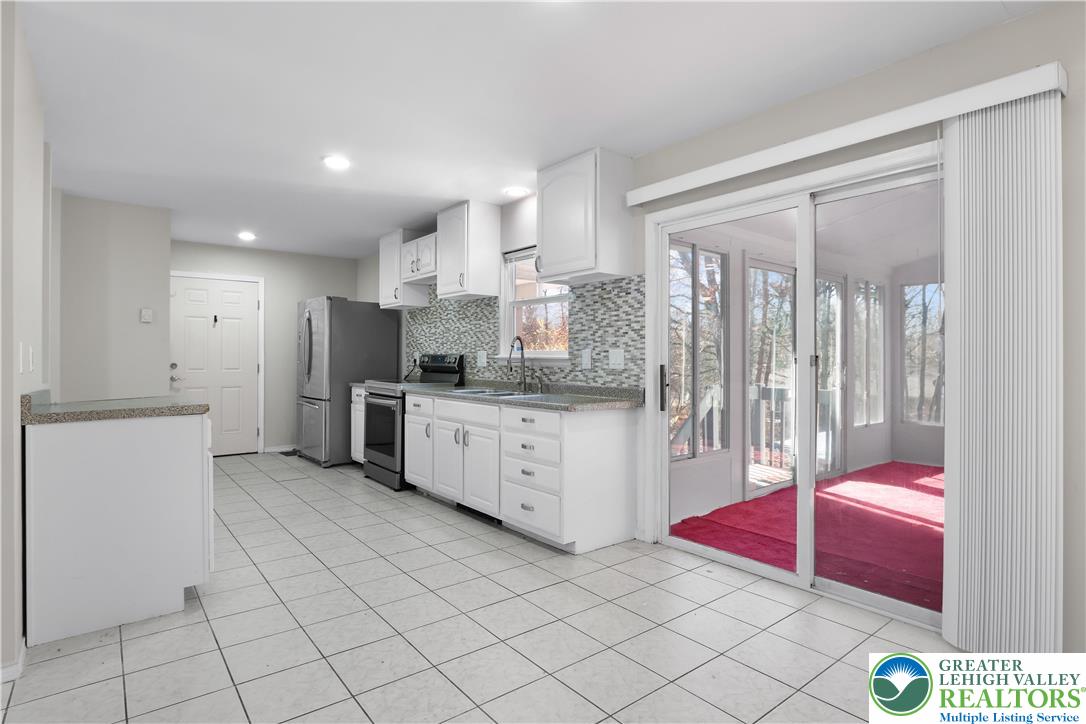 798 Sullivan Trail Scotrun, PA 18355 - Photo 17 of 46 a kitchen with stainless steel appliances kitchen island granite countertop a sink and cabinets