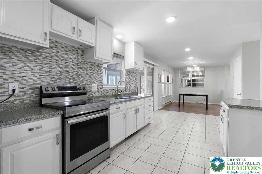 798 Sullivan Trail Scotrun, PA 18355 - Photo 19 of 46 a kitchen with granite countertop a stove sink and cabinets