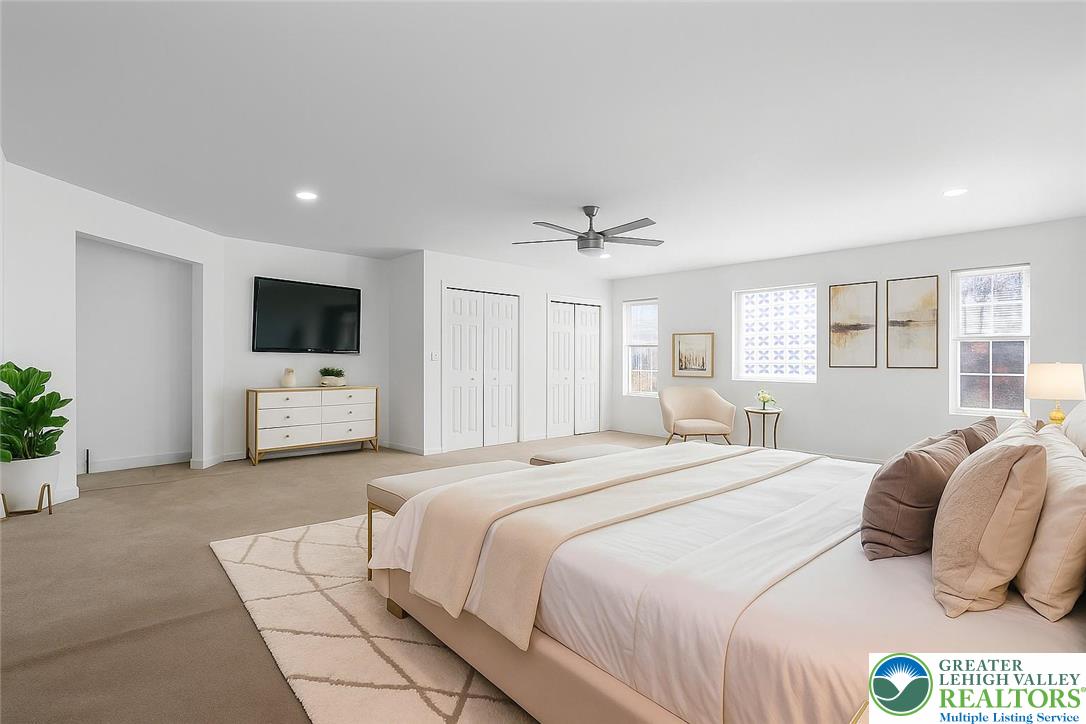 798 Sullivan Trail Scotrun, PA 18355 - Photo 26 of 46 a bedroom with a large bed a flat tv screen and white walls