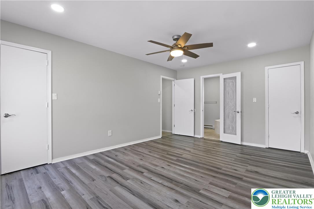 798 Sullivan Trail Scotrun, PA 18355 - Photo 30 of 46 a view of an empty room with wooden floor and a ceiling fan