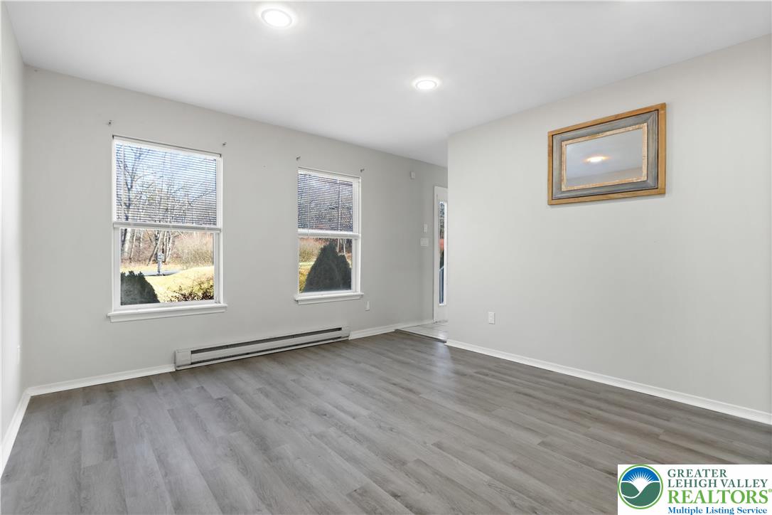798 Sullivan Trail Scotrun, PA 18355 - Photo 7 of 46 an empty room with wooden floor and windows