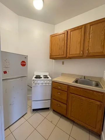 a kitchen with a stove a sink and a refrigerator
