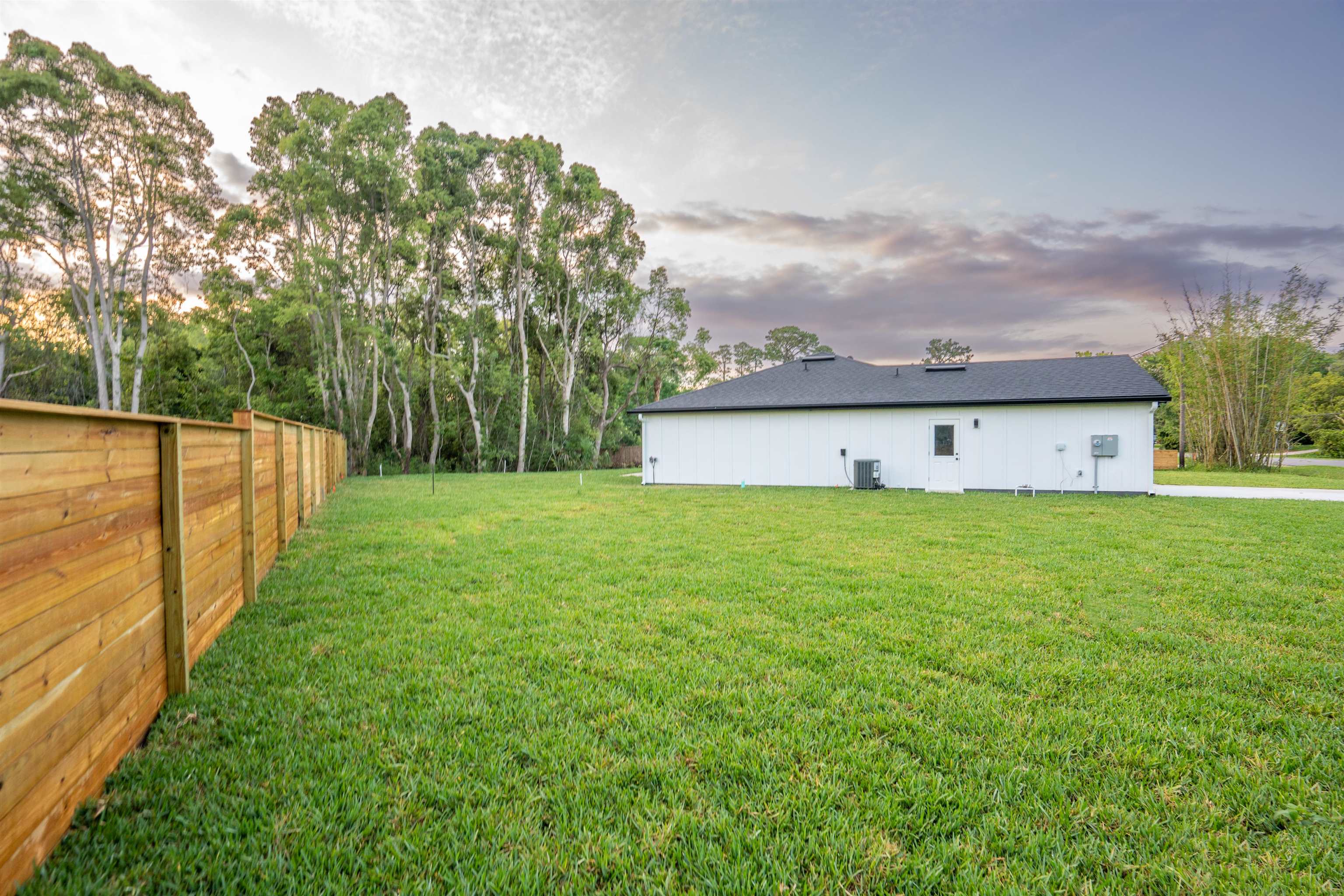 411 Royal Road St. Augustine, FL 32086 - Photo 12 of 43 a front view of house with yard and trees in the background