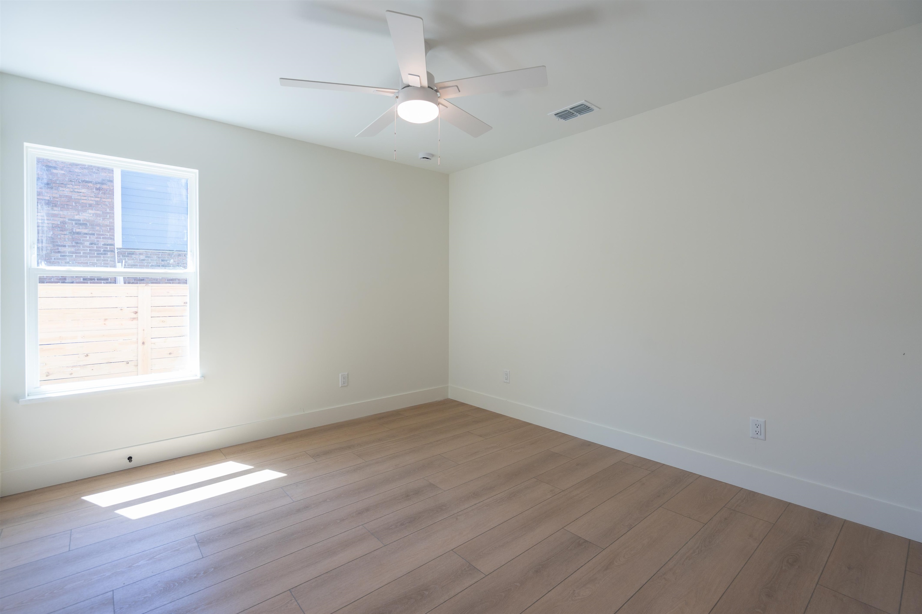 411 Royal Road St. Augustine, FL 32086 - Photo 16 of 43 an empty room with wooden floor and windows