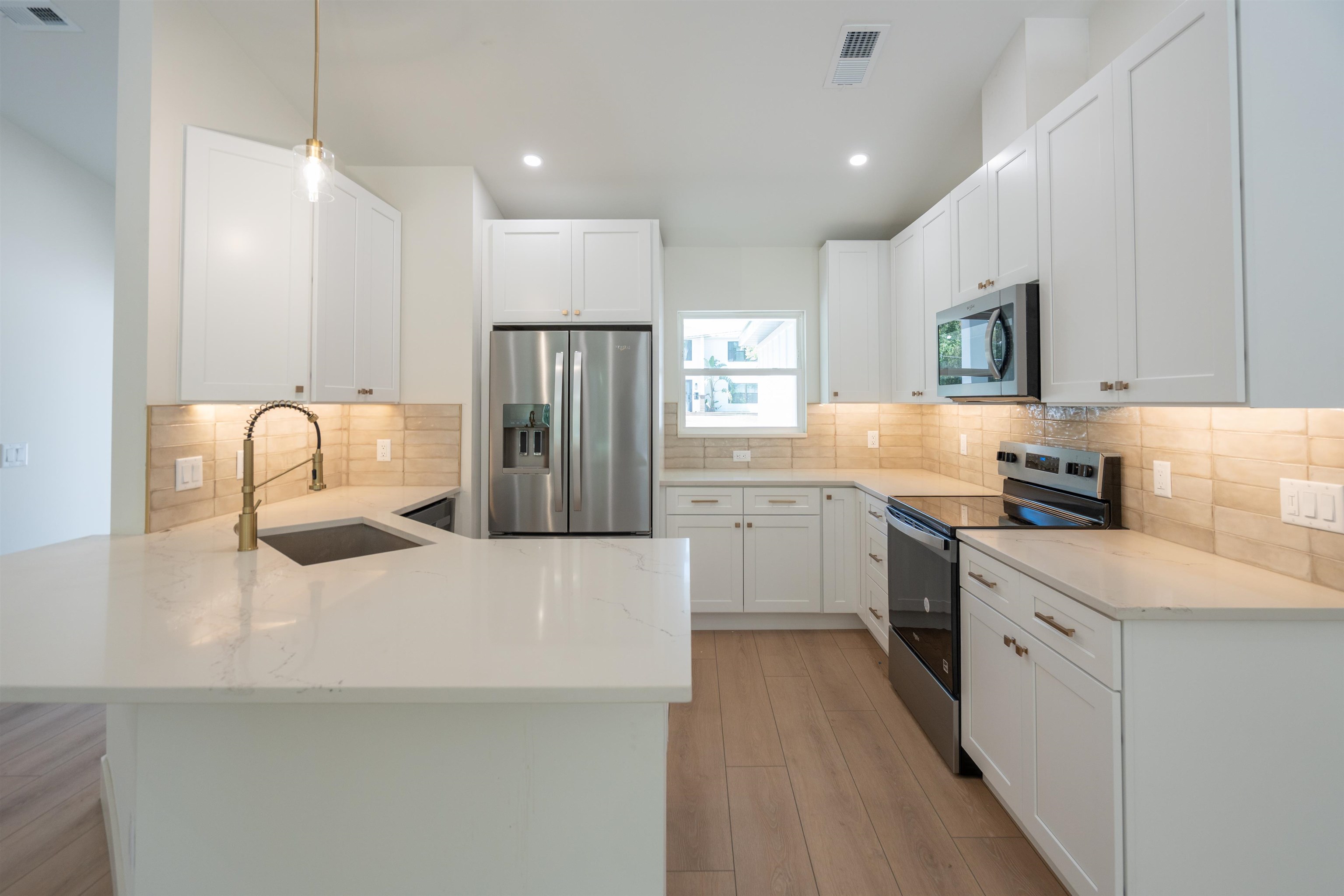 411 Royal Road St. Augustine, FL 32086 - Photo 23 of 43 a kitchen with a sink a refrigerator and cabinets