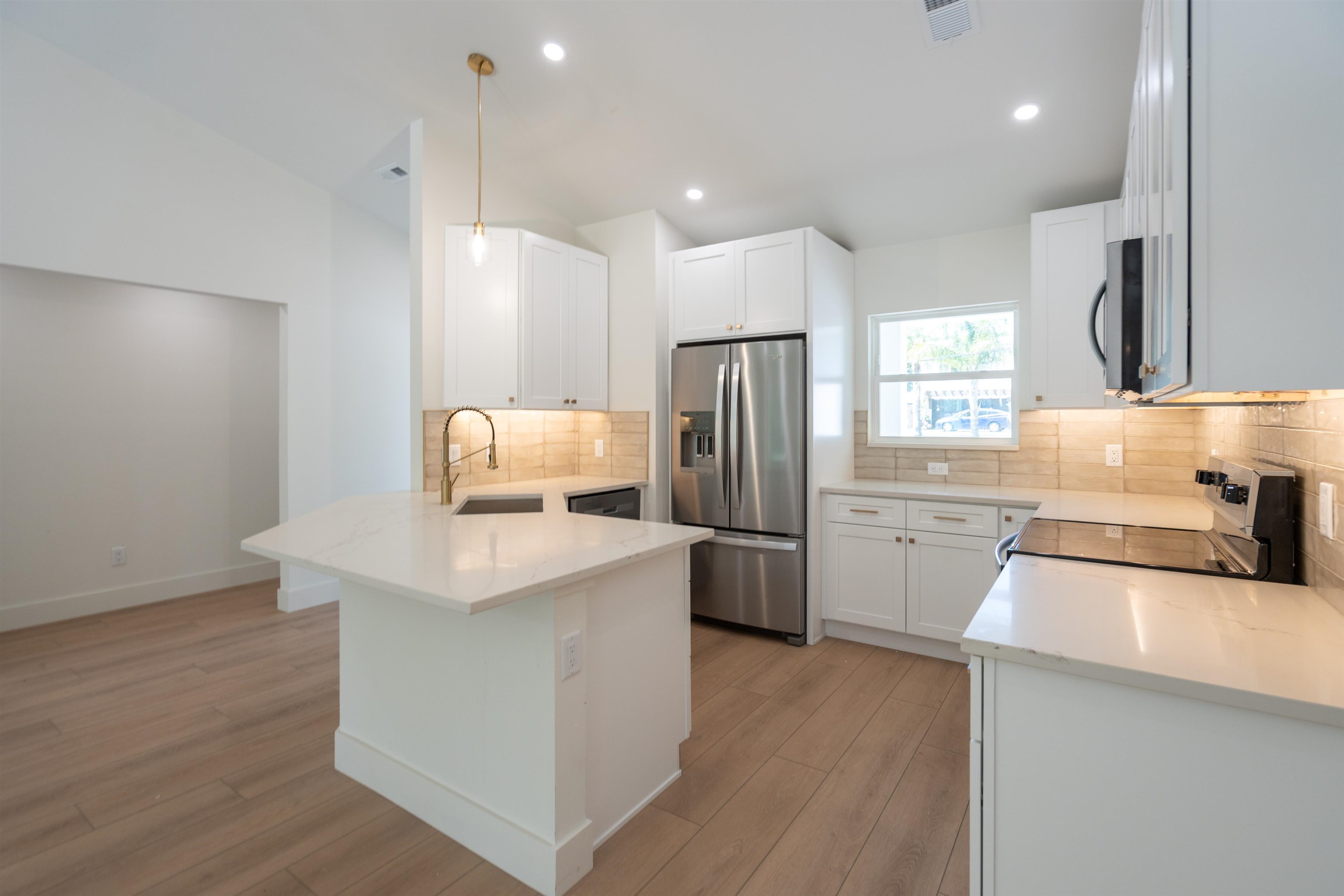 411 Royal Road St. Augustine, FL 32086 - Photo 24 of 43 a kitchen with a refrigerator a sink dishwasher with a dining table and chairs