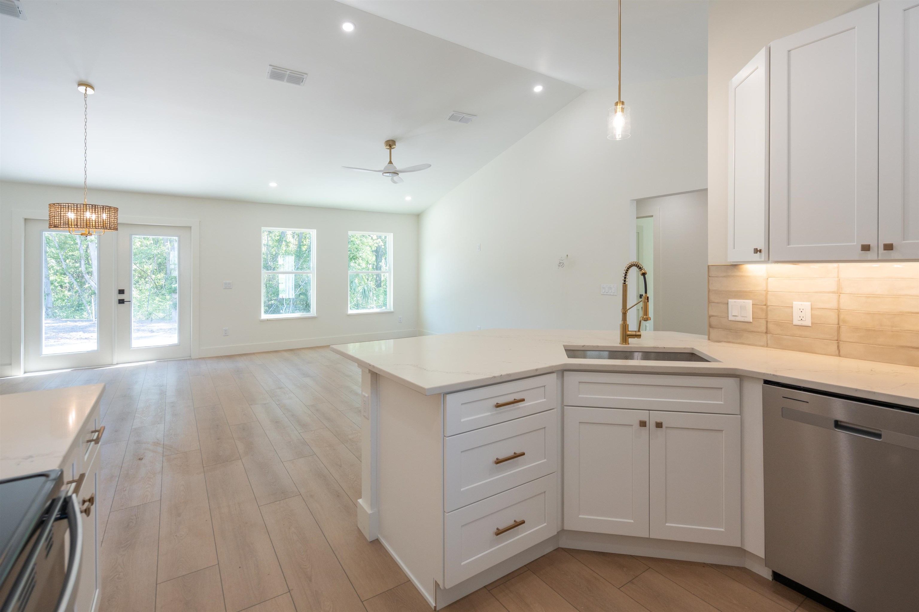 411 Royal Road St. Augustine, FL 32086 - Photo 25 of 43 a kitchen with white cabinets and sink