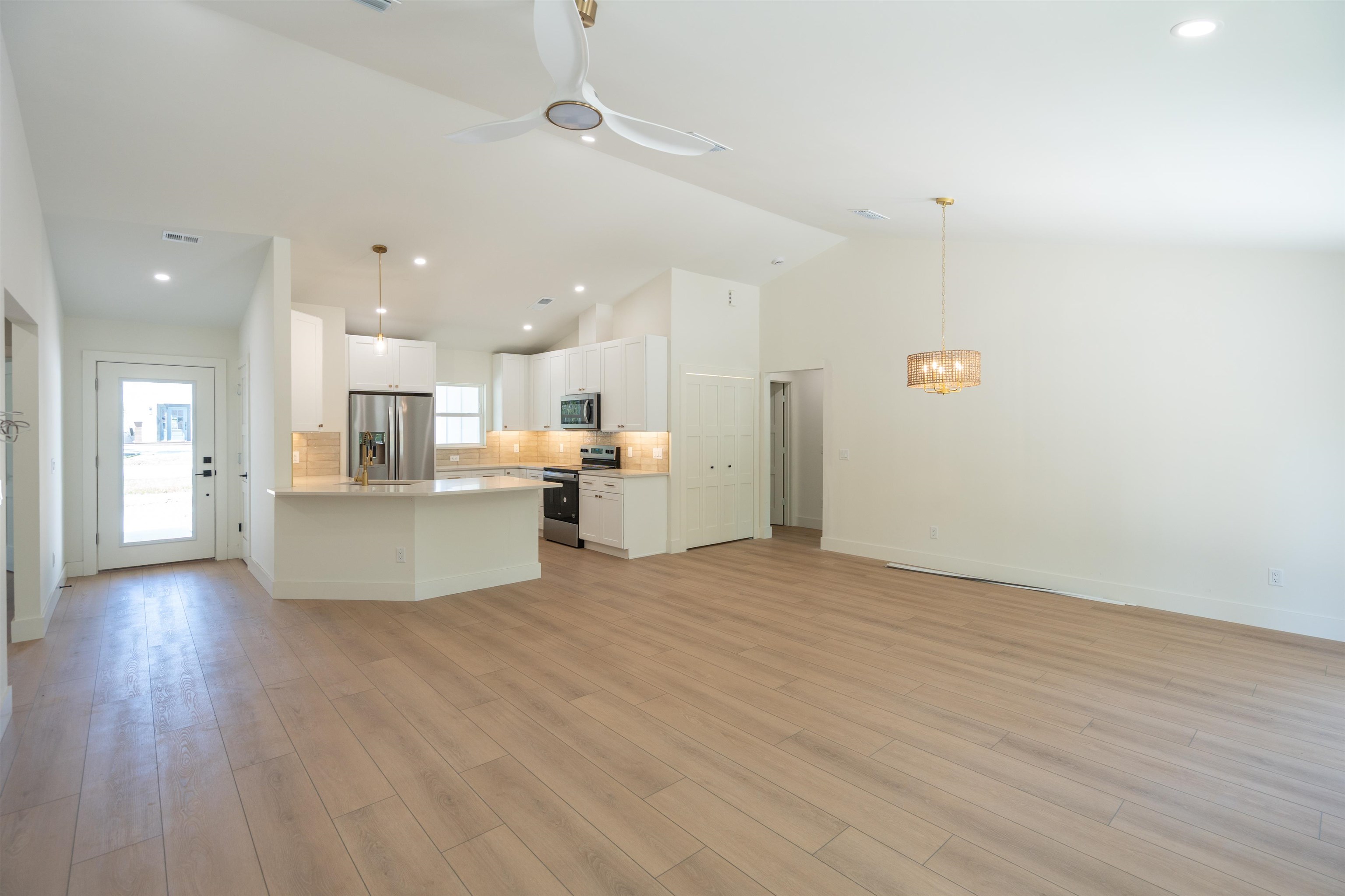 411 Royal Road St. Augustine, FL 32086 - Photo 27 of 43 a view of kitchen and empty room with wooden floor