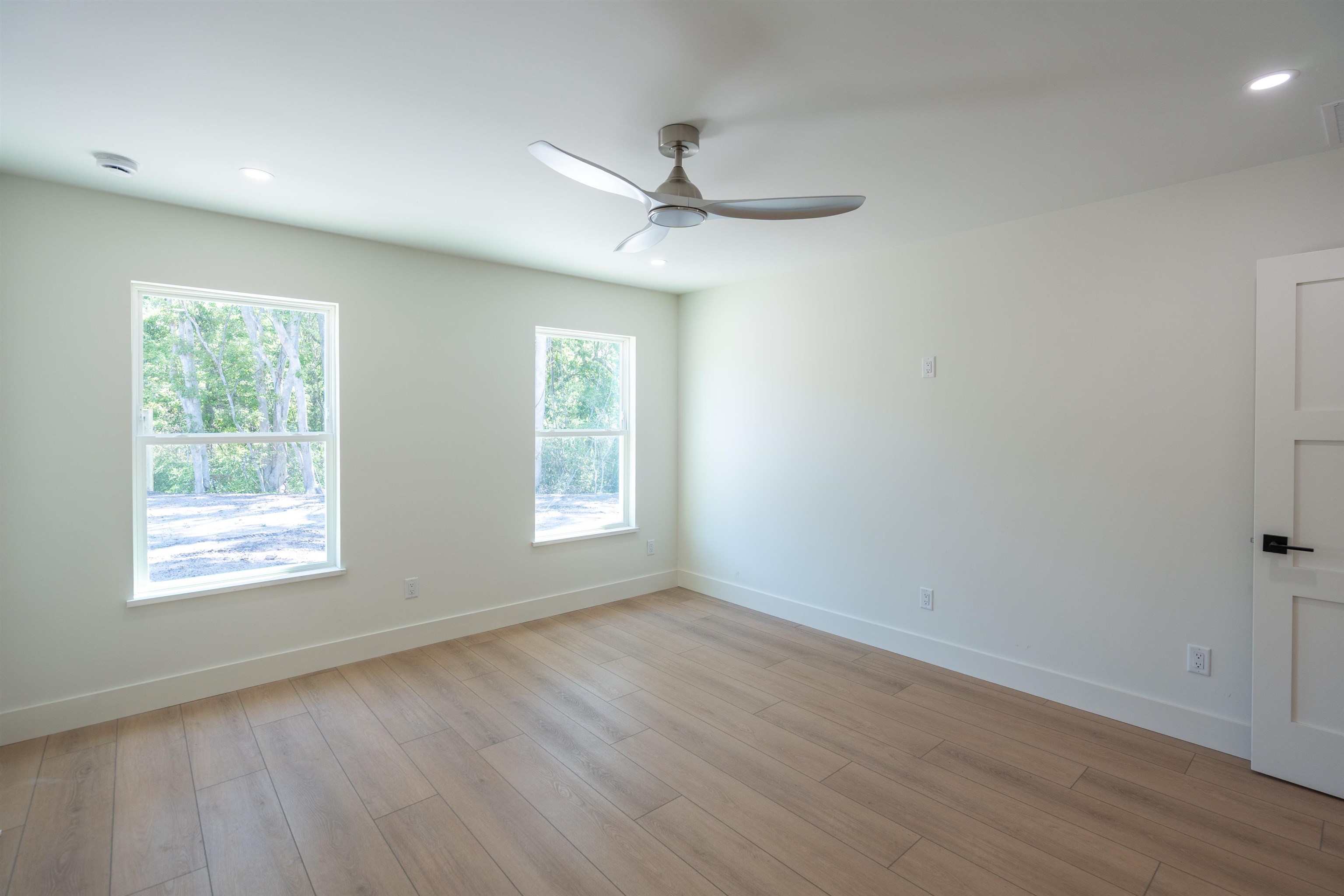 411 Royal Road St. Augustine, FL 32086 - Photo 31 of 43 an empty room with wooden floor ceiling fan and windows
