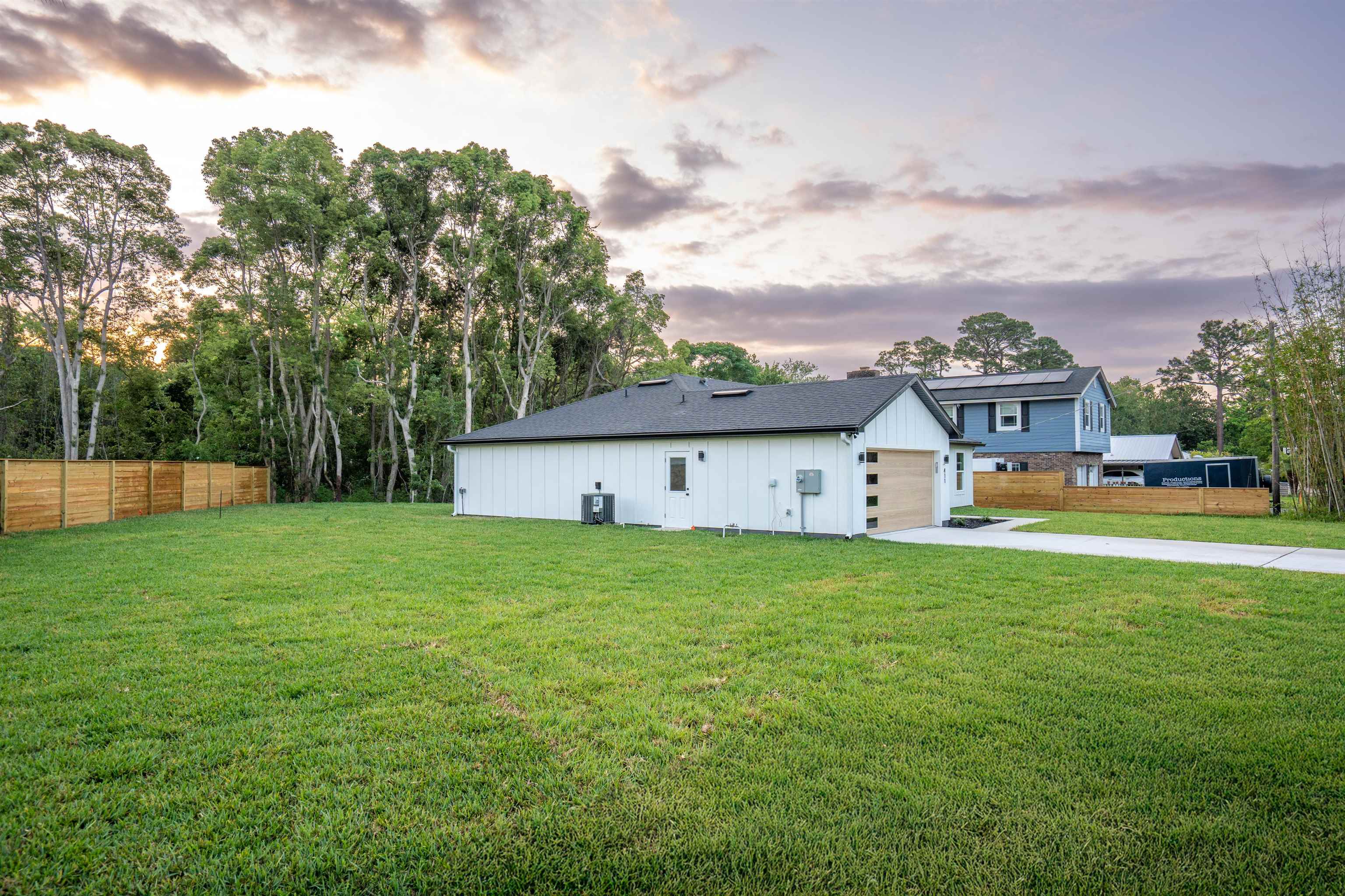 411 Royal Road St. Augustine, FL 32086 - Photo 5 of 43 a view of a big house with a big yard and large trees