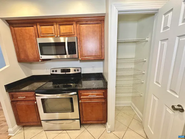 a kitchen with wooden cabinets and a stove top oven