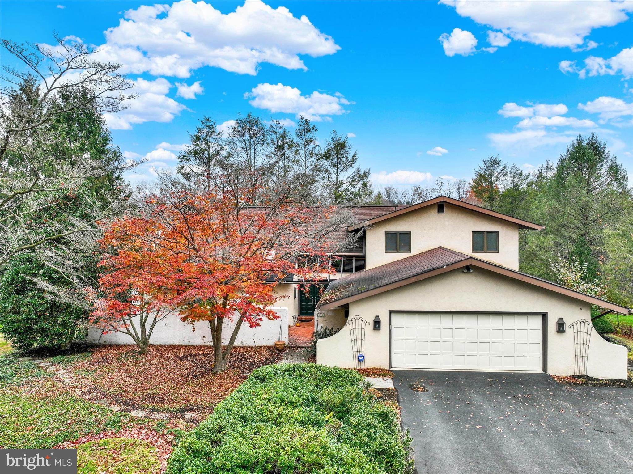 a front view of a house with a tree