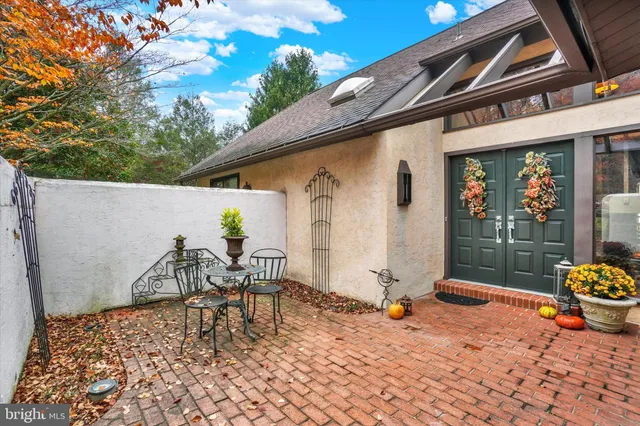 a backyard of a house with barbeque oven table and chairs