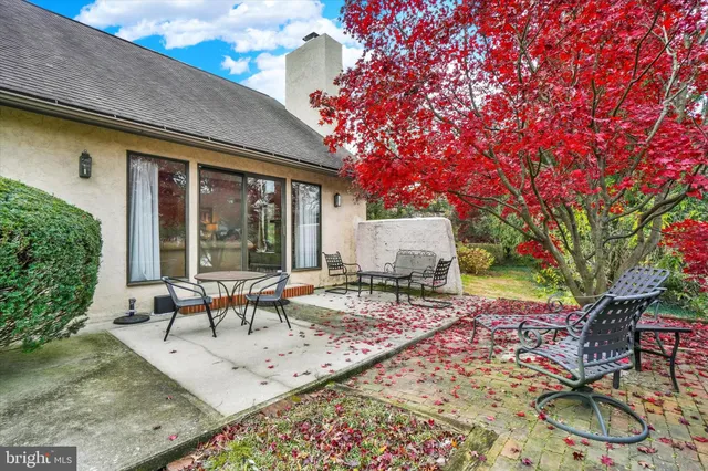 a view of a house with backyard sitting area and garden