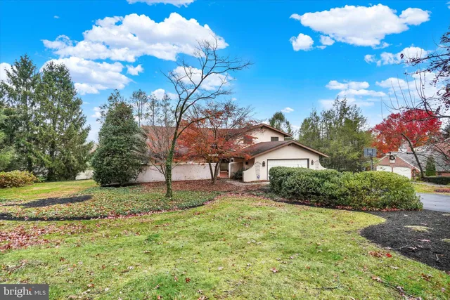 a backyard of a house with lots of green space and fountain