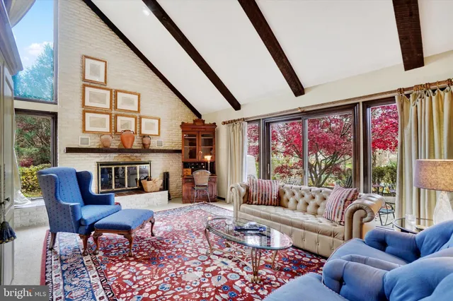 a living room with furniture and a floor to ceiling window