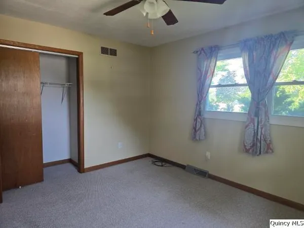 an empty room with a empty space and windows