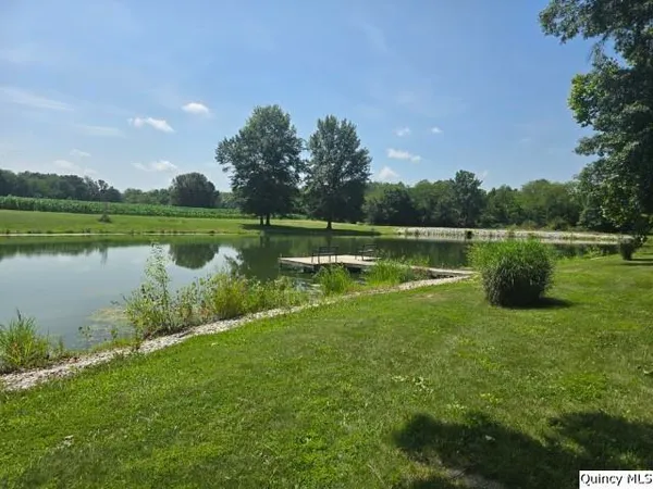 a wooden bench sitting next to a lake