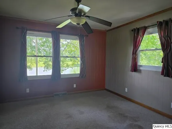 a view of room with window and ceiling fan