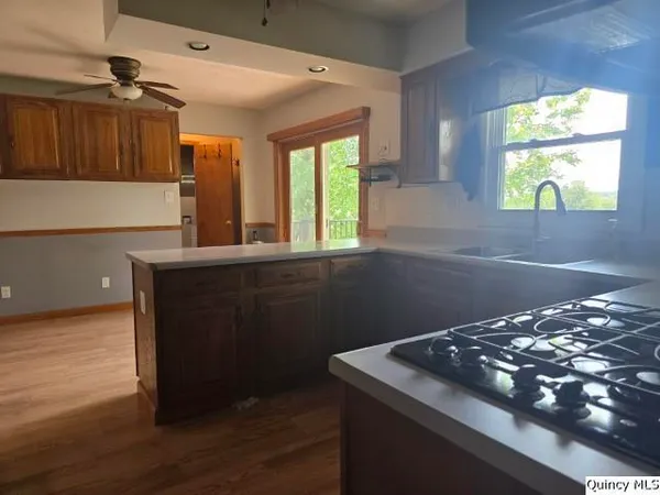 a kitchen with a wooden floor and a window