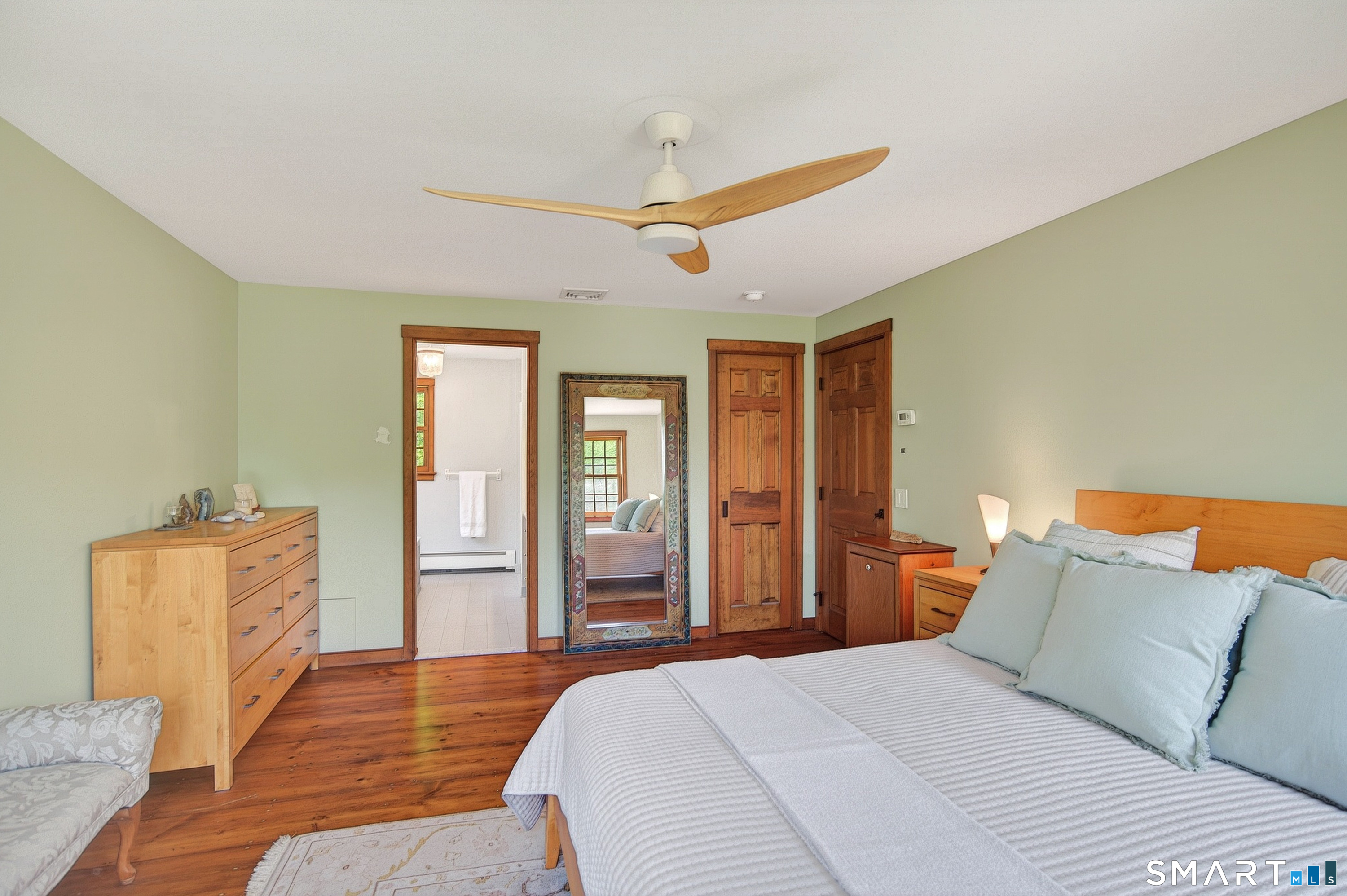174 Huntingtown Road Newtown, CT 06470 - Photo 24 of 40 a bedroom with a bed dresser and wooden floor
