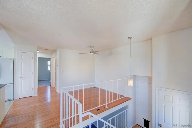 a view of a room with wooden floor