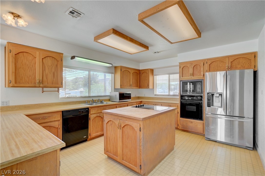 590 East Encinitas Street Searchlight, NV 89046 - Photo 12 of 39 This spacious kitchen offers ample cabinetry, modern appliances, and a convenient island cooktop.