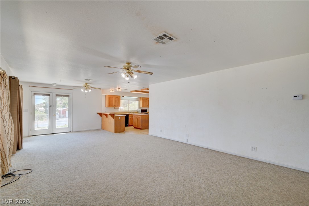 590 East Encinitas Street Searchlight, NV 89046 - Photo 15 of 39 This expansive great room seamlessly connects to the kitchen, offering an adaptable layout.