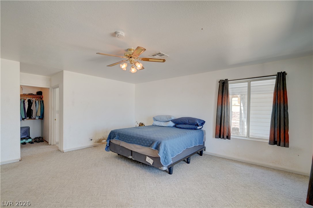 590 East Encinitas Street Searchlight, NV 89046 - Photo 16 of 39 This spacious bedroom offers ample natural light and a dedicated closet for storage.
